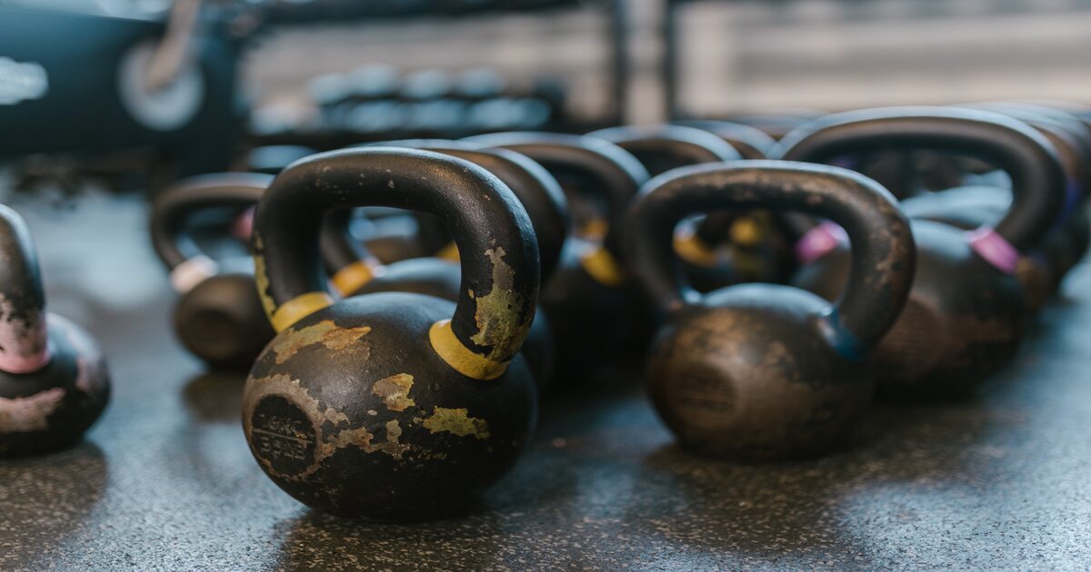 An image of essential CrossFit equipment - kettlebells on a floor.