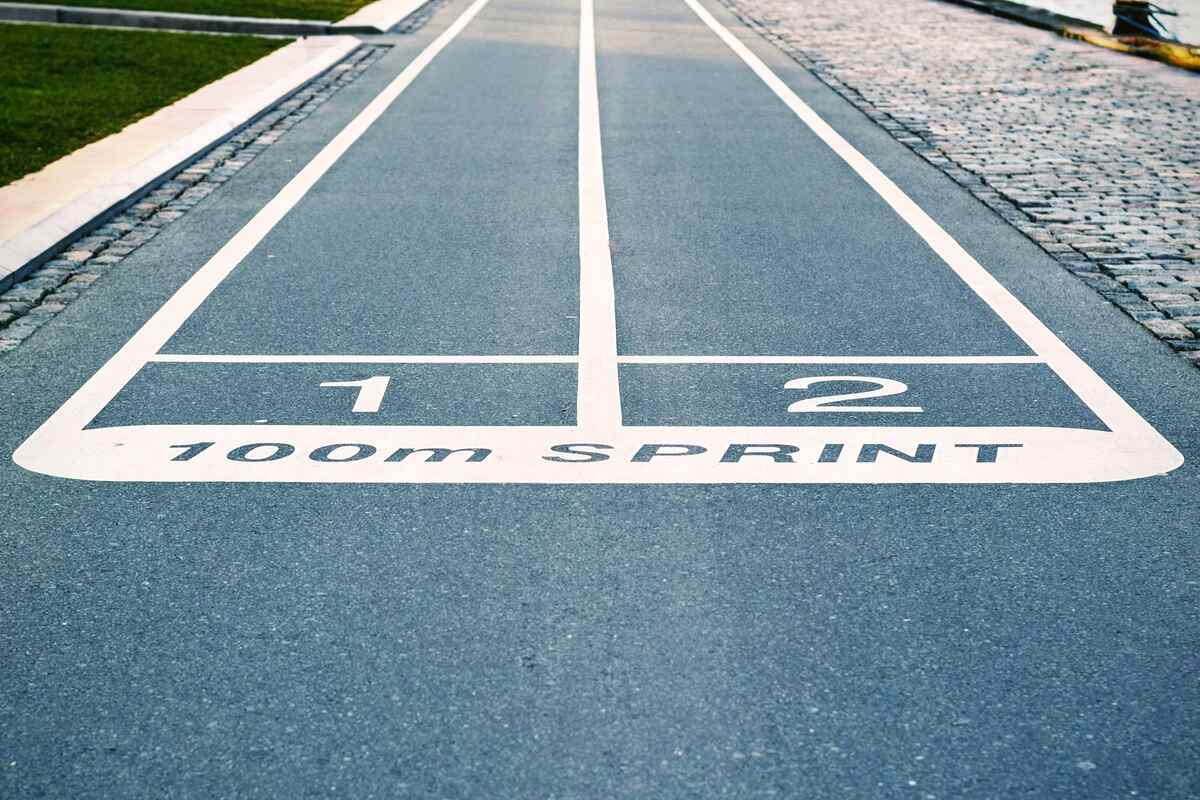 Pavement with 100-metre sprint tracks painted on it.